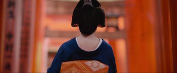 Movie still from “Samsara” (2011), directed by Ron Fricke – A woman in a blue dress holding an orange bag; Close Up shot, Low angle
