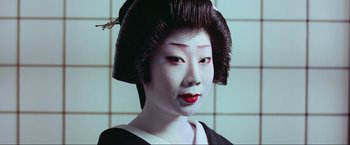 Movie still from “Samsara” (2011), directed by Ron Fricke – A geisha is wearing a black and white outfit; Close Up shot, Overhead angle
