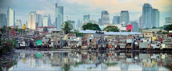 Movie still from “Samsara” (2011), directed by Ron Fricke – A view of a city from across a body of water; Extreme Wide shot, Low angle