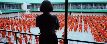 Movie still from “Samsara” (2011), directed by Ron Fricke – A woman standing in front of a large group of people; Extreme Wide shot, High angle