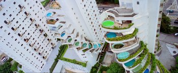 Movie still from “Samsara” (2011), directed by Ron Fricke – An aerial view of a building with many pools; Extreme Wide shot, Overhead angle