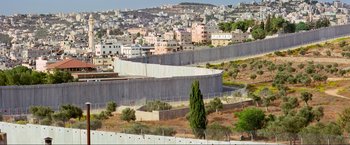 Movie still from “Samsara” (2011), directed by Ron Fricke – A view of a city from a hill with a fence around it; Extreme Wide shot, High angle
