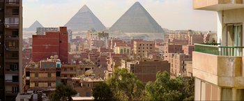 Movie still from “Samsara” (2011), directed by Ron Fricke – A view of the pyramids of gizeh from a distance; Extreme Wide shot, Low angle