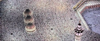 Movie still from “Samsara” (2011), directed by Ron Fricke – A large group of people standing on the ground; Extreme Wide shot, Overhead angle