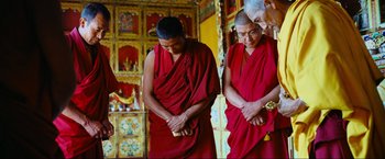 Movie still from “Samsara” (2011), directed by Ron Fricke – Two men in red robes standing next to each other; Medium shot, High angle