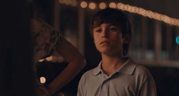 Movie still from “Big Time Adolescence” (2019), directed by Jason Orley – A young man standing next to a woman; Close Up shot, Over the shoulder angle
