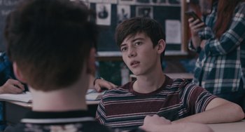 Movie still from “Big Time Adolescence” (2019), directed by Jason Orley – A young man sitting in front of another young man; Close Up shot, Over the shoulder angle