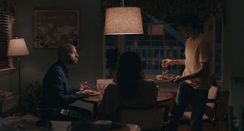 Movie still from “Big Time Adolescence” (2019), directed by Jason Orley – A group of people sitting around a table eating food; Medium shot, Over the shoulder angle