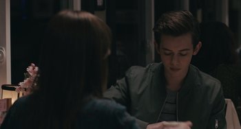 Movie still from “Big Time Adolescence” (2019), directed by Jason Orley – A man and a woman are sitting at a table; Close Up shot, Over the shoulder angle