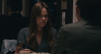 Movie still from “Big Time Adolescence” (2019), directed by Jason Orley – A woman sitting in front of a man at a dinner table; Close Up shot, Over the shoulder angle