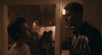 Movie still from “Big Time Adolescence” (2019), directed by Jason Orley – Two men are talking in a room; Medium shot, Over the shoulder angle