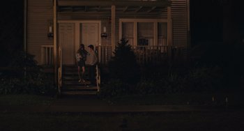 Movie still from “Big Time Adolescence” (2019), directed by Jason Orley – A couple of people that are standing on some steps; Wide shot, Over the shoulder angle