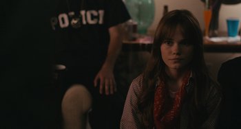 Movie still from “Big Time Adolescence” (2019), directed by Jason Orley – A woman sitting in front of a man in a room; Close Up shot, Over the shoulder angle