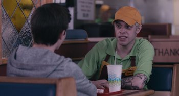 Movie still from “Big Time Adolescence” (2019), directed by Jason Orley – A man sitting at a table in front of another man; Close Up shot, Over the shoulder angle