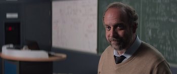 Movie still from “San Andreas” (2015), directed by Brad Peyton – A man with a goatee is standing in front of a whiteboard; Close Up shot, Over the shoulder angle