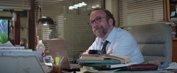 Movie still from “San Andreas” (2015), directed by Brad Peyton – A man sitting in front of a laptop computer on a desk; Close Up shot, Over the shoulder angle