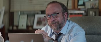 Movie still from “San Andreas” (2015), directed by Brad Peyton – A man sitting at a table looking at a laptop computer; Close Up shot, Over the shoulder angle
