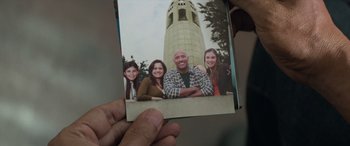 Movie still from “San Andreas” (2015), directed by Brad Peyton – A person holding up a picture of a family; Extreme Close Up shot, Overhead angle