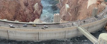Movie still from “San Andreas” (2015), directed by Brad Peyton – An aerial view of a road with a bridge over a river; Extreme Wide shot, Overhead angle