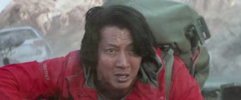 Movie still from “San Andreas” (2015), directed by Brad Peyton – A person with long black hair; Close Up shot, Low angle