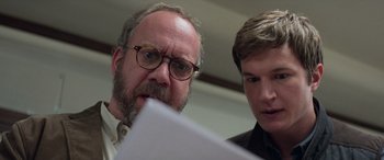 Movie still from “San Andreas” (2015), directed by Brad Peyton – Two men looking at a piece of paper together; Close Up shot, Over the shoulder angle