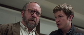 Movie still from “San Andreas” (2015), directed by Brad Peyton – A man with a beard and glasses and a man with a beard and glasses; Close Up shot, Low angle