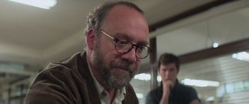 Movie still from “San Andreas” (2015), directed by Brad Peyton – A man with a beard wearing glasses and a brown jacket; Close Up shot, Over the shoulder angle