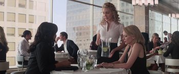 Movie still from “San Andreas” (2015), directed by Brad Peyton – A group of people sitting at a table with food; Medium shot, Over the shoulder angle