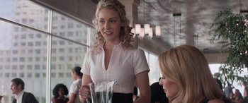 Movie still from “San Andreas” (2015), directed by Brad Peyton – A woman standing at a table in a restaurant; Medium shot, Over the shoulder angle