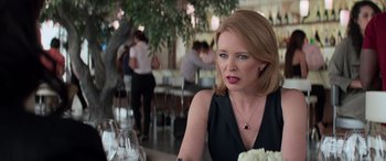 Movie still from “San Andreas” (2015), directed by Brad Peyton – A woman sitting in front of a table with glasses of wine; Close Up shot, Over the shoulder angle