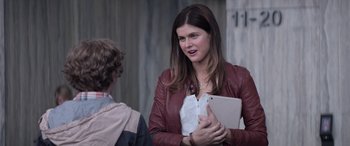 Movie still from “San Andreas” (2015), directed by Brad Peyton – A woman in a red leather jacket holding a tablet; Medium shot, Over the shoulder angle