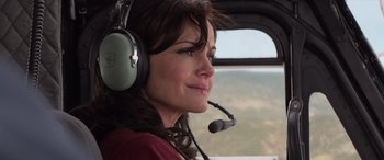 Movie still from “San Andreas” (2015), directed by Brad Peyton – A woman wearing headphones looking out the window of an airplane; Close Up shot, Over the shoulder angle