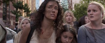 Movie still from “San Andreas” (2015), directed by Brad Peyton – A group of people walking down a street with buildings in the background; Close Up shot, High angle