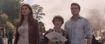 Movie still from “San Andreas” (2015), directed by Brad Peyton – A group of people standing next to each other on a field; Medium shot, Low angle