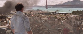 Movie still from “San Andreas” (2015), directed by Brad Peyton – A view of a city with a bridge in the background; Medium shot, Over the shoulder angle