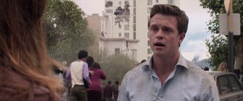 Movie still from “San Andreas” (2015), directed by Brad Peyton – A man standing in front of a group of people; Close Up shot, Over the shoulder angle