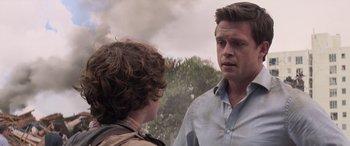 Movie still from “San Andreas” (2015), directed by Brad Peyton – A man talking to a young boy in a field; Close Up shot, Over the shoulder angle