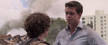 Movie still from “San Andreas” (2015), directed by Brad Peyton – A man and a boy are standing next to each other; Close Up shot, Over the shoulder angle