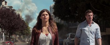 Movie still from “San Andreas” (2015), directed by Brad Peyton – A woman in a white shirt and a red jacket; Medium shot, Low angle