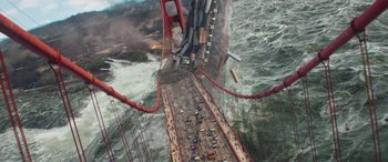 Movie still from “San Andreas” (2015), directed by Brad Peyton – An aerial view of a bridge that is falling into the ocean; Extreme Wide shot, High angle