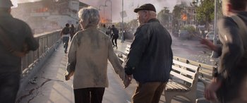 Movie still from “San Andreas” (2015), directed by Brad Peyton – An older man and woman holding hands on a bench; Wide shot, Over the shoulder angle