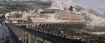 Movie still from “San Andreas” (2015), directed by Brad Peyton – A large cruise ship in the water near a pier; Extreme Wide shot, High angle