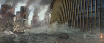Movie still from “San Andreas” (2015), directed by Brad Peyton – A large fire is burning in the background of a city; Extreme Wide shot, High angle