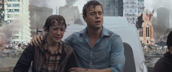 Movie still from “San Andreas” (2015), directed by Brad Peyton – A man and a woman crying in the rain; Medium shot, Low angle