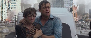 Movie still from “San Andreas” (2015), directed by Brad Peyton – A man and a woman are crying in the rain; Medium shot, Low angle