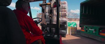 Movie still from “Savage Salvation” (2022), directed by Randall Emmett – A forklift with a pallet of beer on it; Medium shot, Low angle