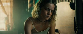 Movie still from “Savage Salvation” (2022), directed by Randall Emmett – A woman sitting down with her head down; Close Up shot, Low angle