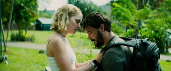 Movie still from “Savage Salvation” (2022), directed by Randall Emmett – A man and a woman standing next to each other in a field; Close Up shot, Low angle