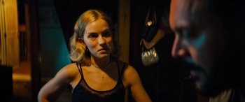 Movie still from “Savage Salvation” (2022), directed by Randall Emmett – A woman in a black top looking at a mirror; Close Up shot, Over the shoulder angle