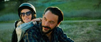 Movie still from “Savage Salvation” (2022), directed by Randall Emmett – A man with a beard and a motorcycle helmet on; Close Up shot, Low angle